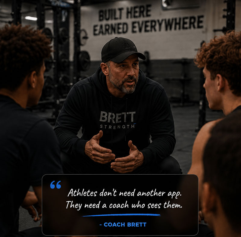 Coach Brett crouched with athletes in the weight room: Athletes don't need another app. They need a coach who sees them.