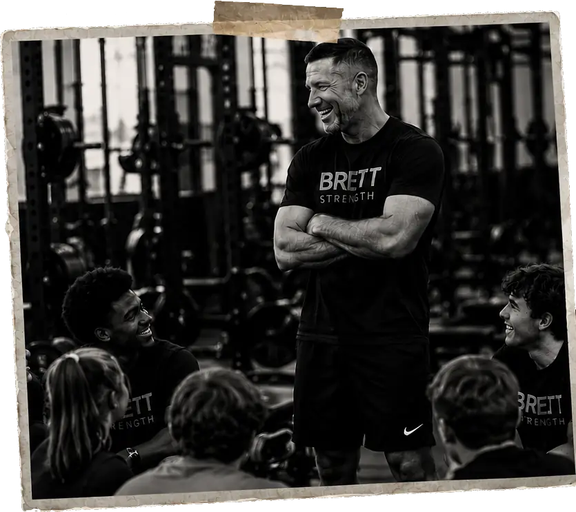 Coach Brett with athletes in the weight room.